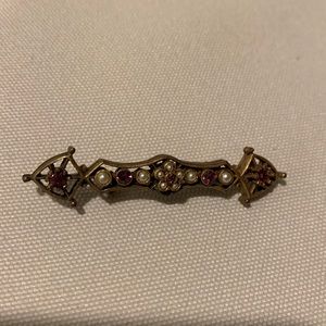 Bronze/brass vintage pin with pearl and amethyst colored crystal stones.